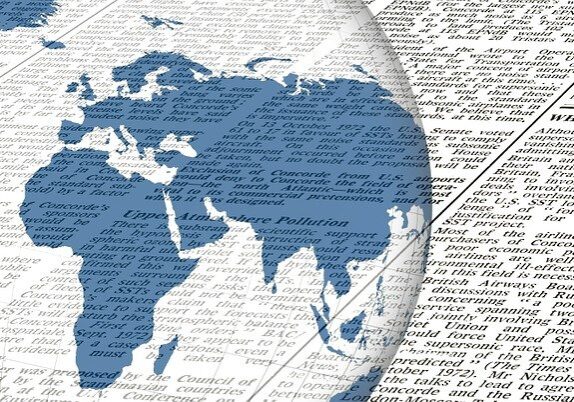 Image of globe and newspaper behind