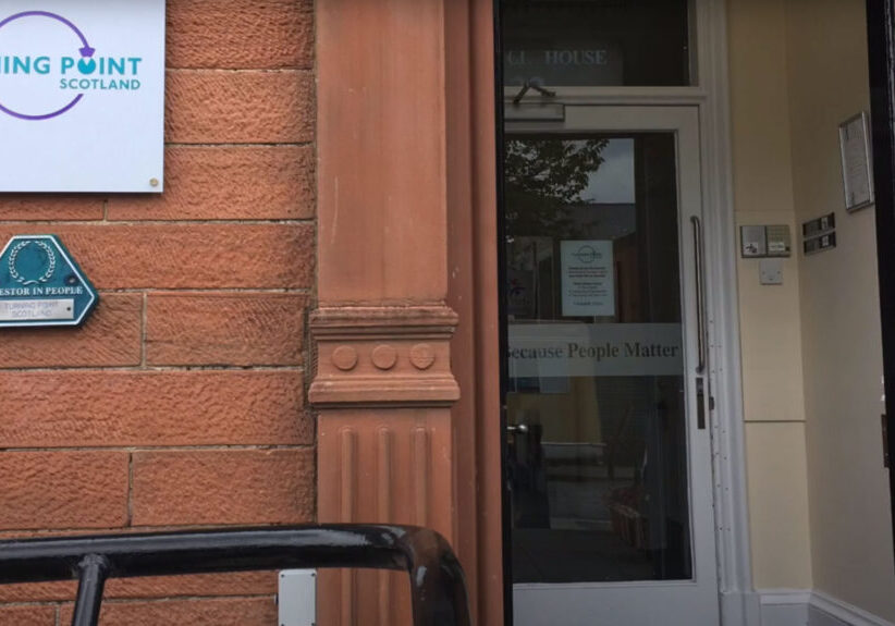 Photo of a glass front door to Turning Point Offices in Dumfries